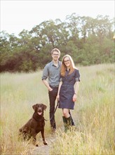 Portrait of young couple with dog. Photo: Jessica Peterson