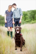 Portrait of young couple with dog. Photo: Jessica Peterson