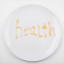 Word HEALTH on white plate. Photo: Jessica Peterson