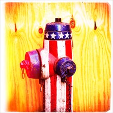 Fire hydrant with American flag pattern.