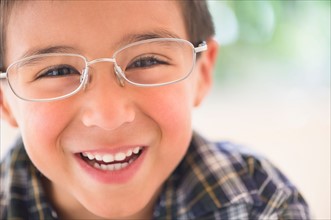 Portrait of boy (6-7) wearing glasses.