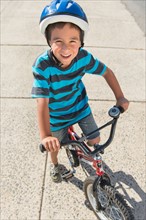 Portrait of boy (6-7) riding bicycle.