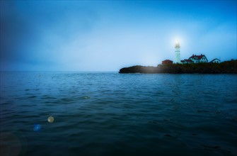 Remote coastline with lighthouse. Portland, Maine.