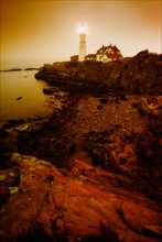 Remote coastline with lighthouse. Portland, Maine.