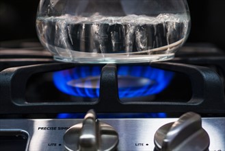 Close-up of water boiling on gas burner.
