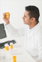 Pharmacist preparing prescription pills.