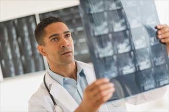 Male doctor reading MRI scan.