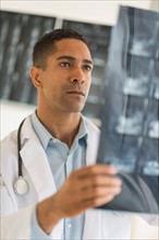 Male doctor reading MRI scan.