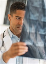 Male doctor reading MRI scan.