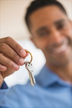 Close up of man's hand holding home key.