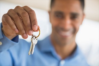 Close up of man's hand holding home key.