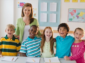 School children (8-9) with female teacher in classroom