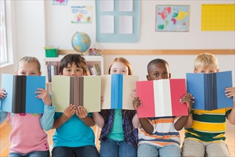 School children (8-9) sitting in row with open books