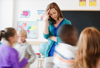 School children (8-9) with female teacher during class