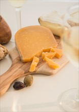 Studio shot of cheese on chopping board