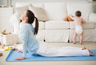 Mother with daughter (6-11 months) doing relaxation exercise