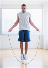 Young man skipping rope