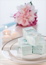 Pastel composition with gifts packages, candles and flowers