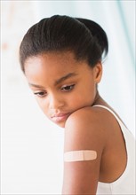 Girl (6-7) with band-aid on arm