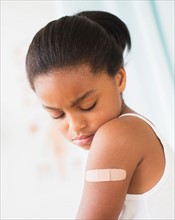 Girl (6-7) with band-aid on arm