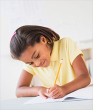 Girl (6-7) doing homework
