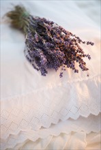 Bundle of dry lavender lying on embroidered pillow