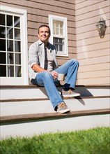Portrait of man relaxing on steps