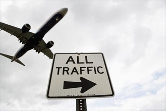 Airplane flying above road signs