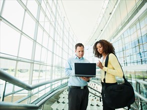 Man and woman using laptop