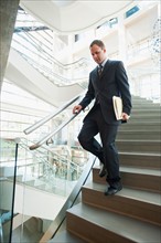 Man walking down stairs in office