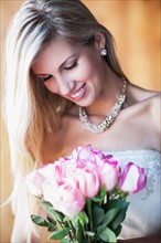 Portrait of smiling bride holding bouquet