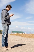 Farmer looking at cell phone