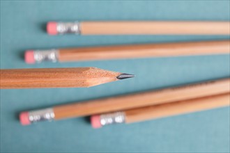 Studio shot of sharpened pencil on blue background