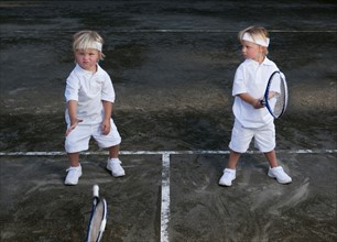 Two boys (2-3) playing tennis