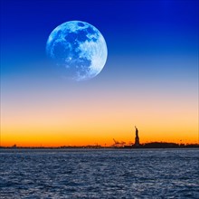 Full moon over Statue of Liberty.