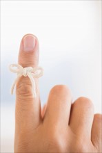 Hand with reminder bow on finger.