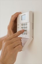 Hand setting code on burglar alarm.