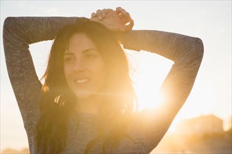 Smiling woman at sunset. Photo : Jamie Grill