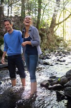 Couple wading in stream. Photo: Jamie Grill