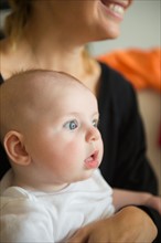 Baby boy (2-5 months) held by mother. Photo: Jamie Grill