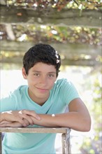 Portrait of smiling teenage boy (14-15) in vineyard. Photo: pauline st.denis