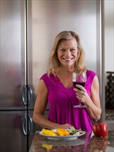Portrait of mature woman with wine glass. Photo : Dan Bannister