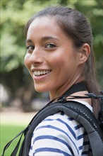 Portrait of young woman with backpack. Photo : Jan Scherders