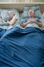 Senior couple sleeping in bed. Photo : Rob Lewine