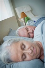 Senior couple sleeping in bed. Photo: Rob Lewine
