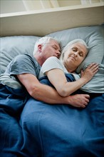 Senior couple embracing and sleeping. Photo: Rob Lewine
