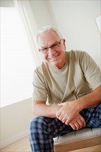 Portrait of cheerful senior man wearing spectacles. Photo : Rob Lewine