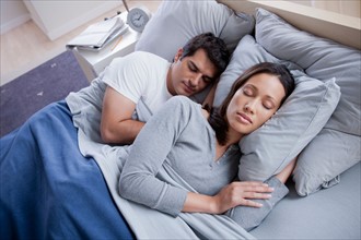 Couple sleeping in bed. Photo : Rob Lewine