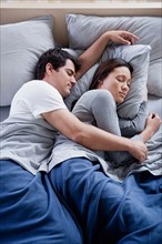 Couple sleeping in bed. Photo : Rob Lewine