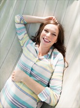 Portrait of pregnant mid adult woman, directly above. Photo : Jessica Peterson